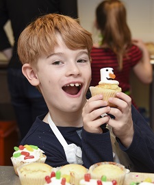 Child holding cupcake 