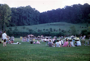 Outdoor concert at Holmdel Park in 1968. Arboretum in background on hill.